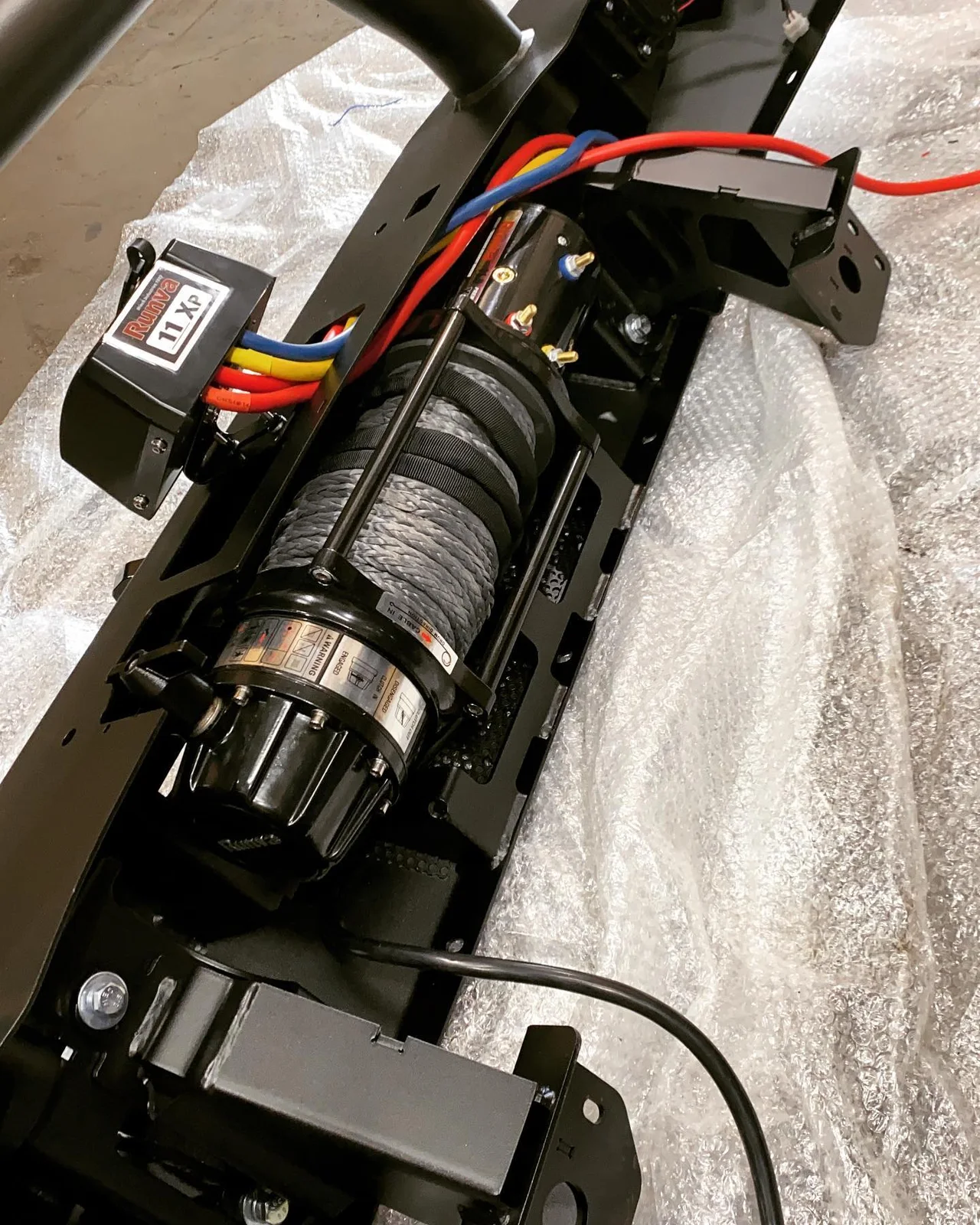Winch fitted into a vehicle mounting cradle